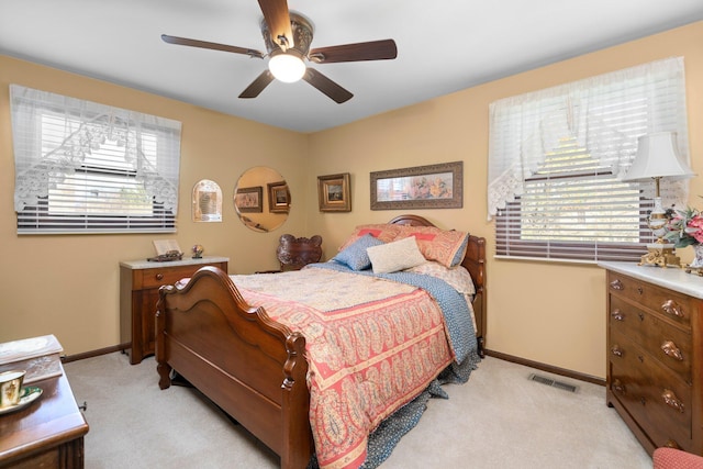16264 White Haven Dr, Northville, MI 48168 - bedroom featuring baseboards, multiple windows, light carpet, and a ceiling fan