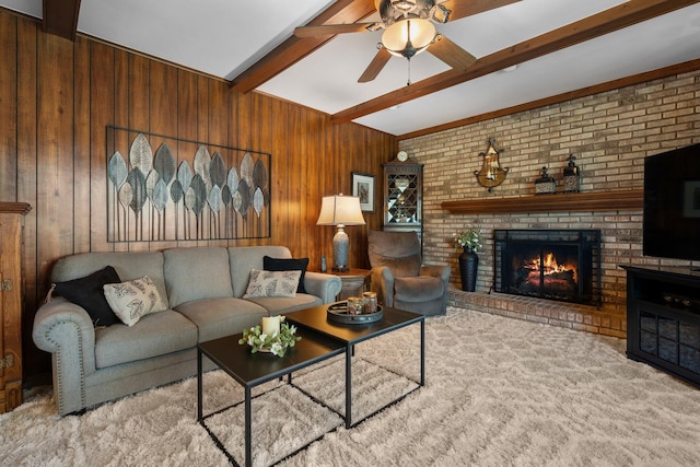 16264 White Haven Dr, Northville, MI 48168 - living room featuring beamed ceiling, a fireplace, carpet, a ceiling fan, and wood walls