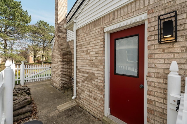 16264 White Haven Dr, Northville, MI 48168 - exterior space with a chimney, fence, and brick siding