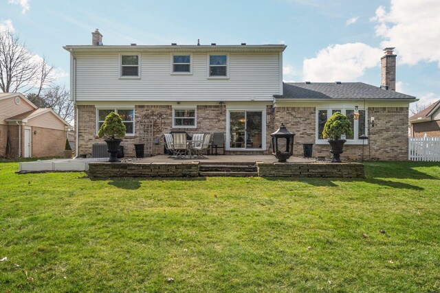 16264 White Haven Dr, Northville, MI 48168 - back of property with a chimney, a patio area, a yard, and brick siding