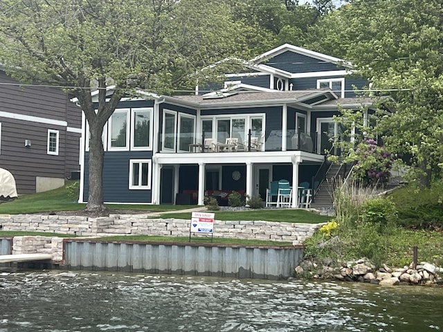 940 E Eagle Lake Dr, Kalamazoo, MI 49009 - back of property with a water view, stairs, roof with shingles, and a balcony