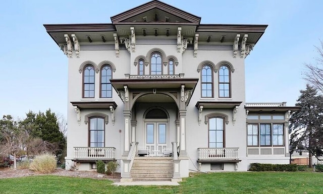 44 Lafayette Ave NE Unit 6, Grand Rapids, MI 49503 - rear view of house with french doors, a lawn, and stucco siding