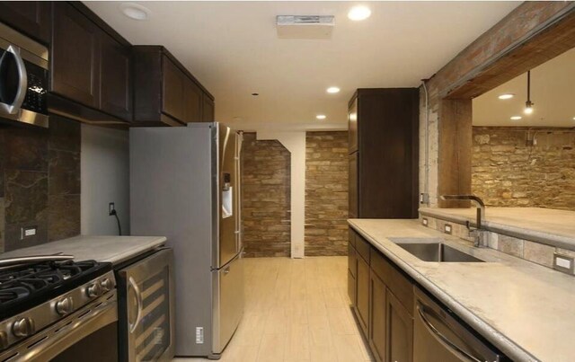 44 Lafayette Ave NE Unit 6, Grand Rapids, MI 49503 - kitchen with a sink, light countertops, light wood finished floors, recessed lighting, and stainless steel appliances