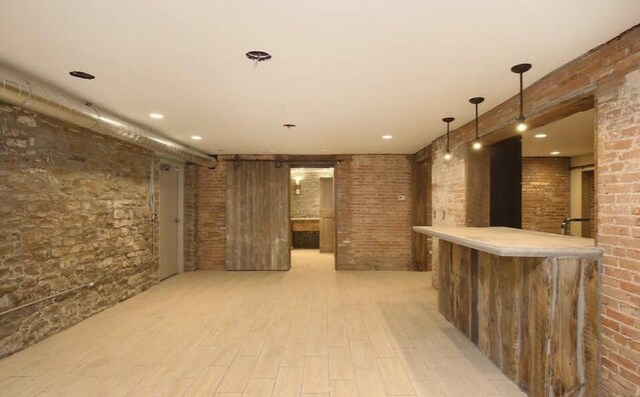 44 Lafayette Ave NE Unit 6, Grand Rapids, MI 49503 - interior space featuring light wood-style flooring, a dry bar, and brick wall