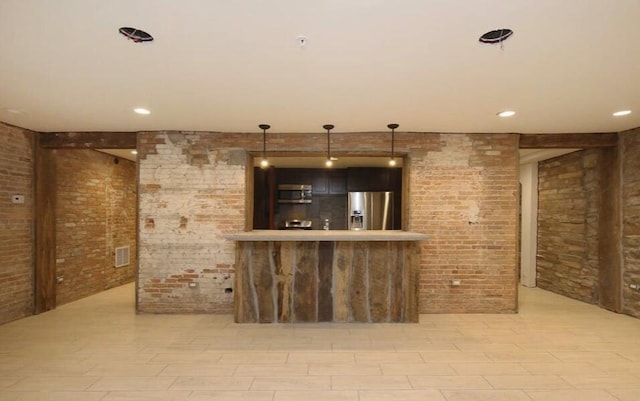 44 Lafayette Ave NE Unit 6, Grand Rapids, MI 49503 - bar featuring stainless steel appliances, brick wall, visible vents, and hanging light fixtures