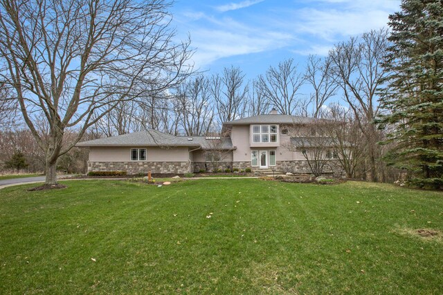 8023 Trail Rdg, Dexter, MI 48130 - prairie-style house with a front yard and stone siding