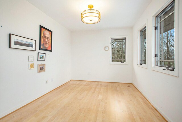 8023 Trail Rdg, Dexter, MI 48130 - empty room with baseboards, plenty of natural light, and wood finished floors