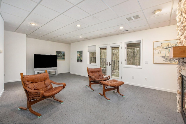 8023 Trail Rdg, Dexter, MI 48130 - living area with dark carpet, baseboards, a drop ceiling, and visible vents