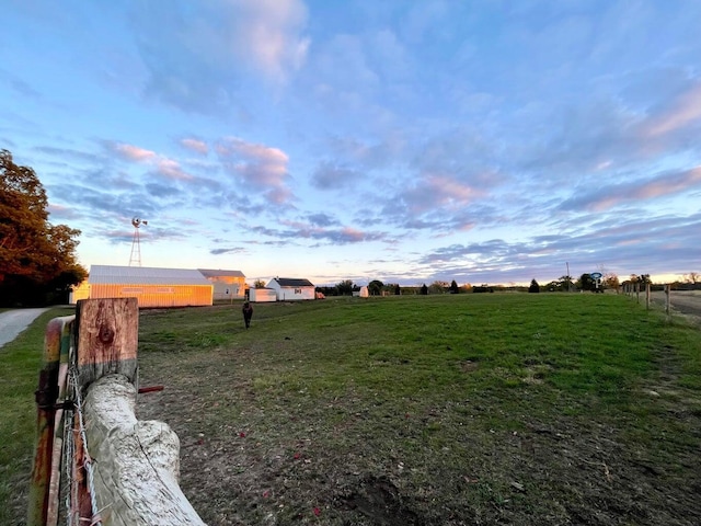 yard at dusk featuring driveway