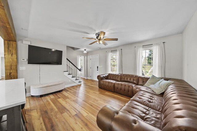 5427 Vrooman Rd, Jackson, MI 49201 - living room featuring hardwood / wood-style floors, stairway, ceiling fan, and baseboards