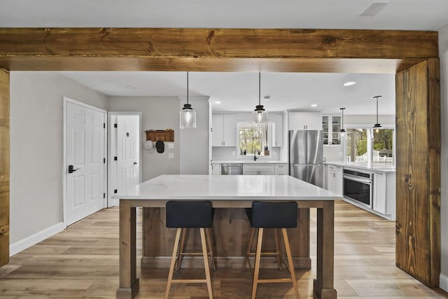 5427 Vrooman Rd, Jackson, MI 49201 - kitchen with a healthy amount of sunlight, stainless steel appliances, light wood-type flooring, and a sink