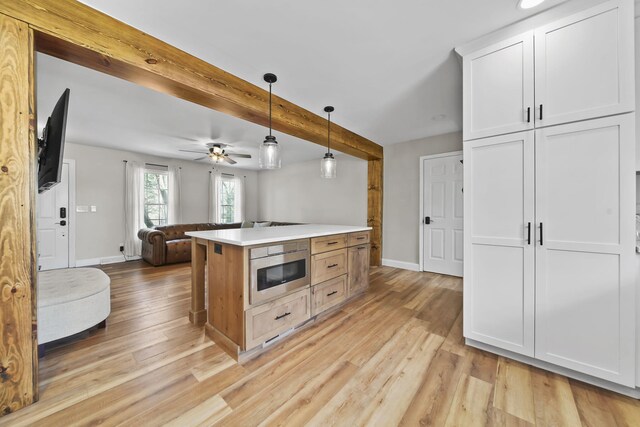 5427 Vrooman Rd, Jackson, MI 49201 - kitchen with baseboards, open floor plan, and light wood finished floors