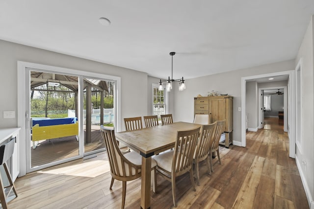 5427 Vrooman Rd, Jackson, MI 49201 - dining space with an inviting chandelier, light wood-type flooring, and baseboards