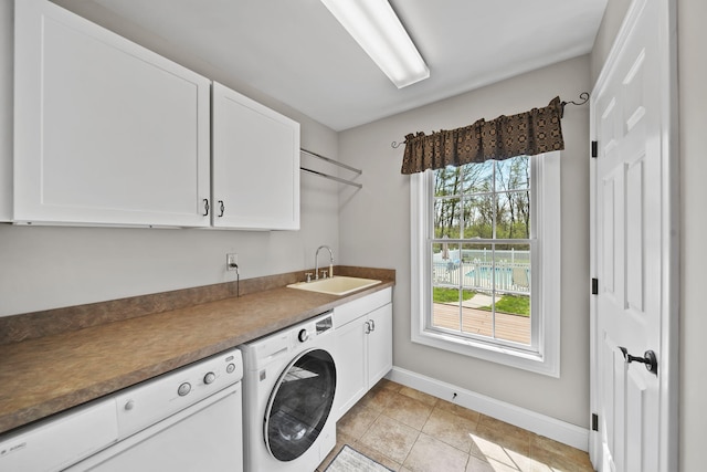 5427 Vrooman Rd, Jackson, MI 49201 - washroom featuring a sink, cabinet space, light tile patterned floors, washing machine and dryer, and baseboards