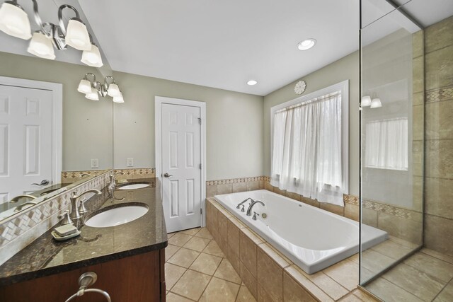 5427 Vrooman Rd, Jackson, MI 49201 - full bathroom with a jetted tub, a sink, double vanity, and tile patterned floors