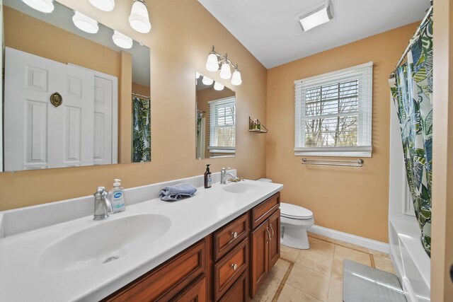 5427 Vrooman Rd, Jackson, MI 49201 - full bathroom with baseboards, toilet, double vanity, and a sink
