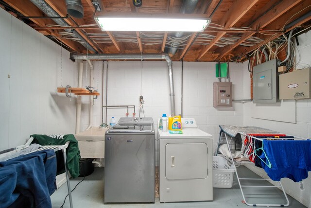 5427 Vrooman Rd, Jackson, MI 49201 - laundry area with concrete block wall, washer and dryer, electric panel, and laundry area