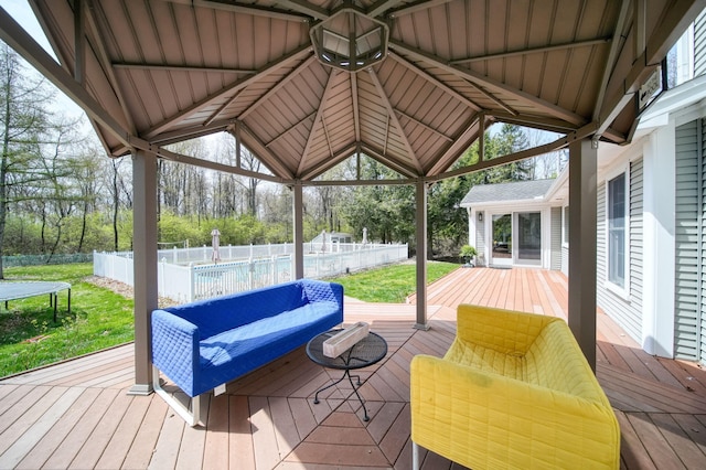5427 Vrooman Rd, Jackson, MI 49201 - wooden deck with a yard, a trampoline, a swimming pool, and fence
