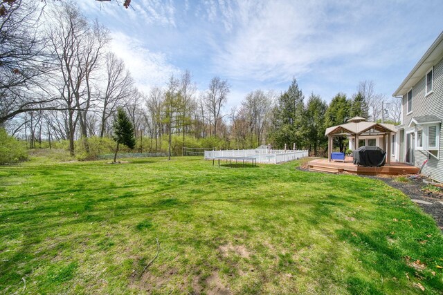 5427 Vrooman Rd, Jackson, MI 49201 - view of yard with a deck, a pool, a gazebo, and fence