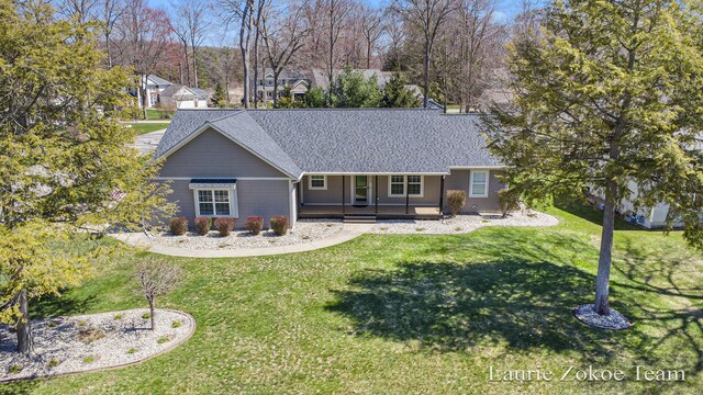 13548 Greenbriar Dr, Grand Haven, MI 49417 - back of house with a lawn, roof with shingles, and a porch