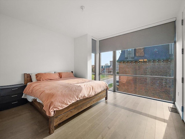 3105 Brush St, Detroit, MI 48201 - bedroom with access to exterior, wood finished floors, and floor to ceiling windows