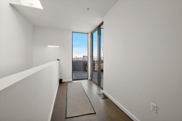 3105 Brush St, Detroit, MI 48201 - hallway with expansive windows, visible vents, wood finished floors, an upstairs landing, and baseboards
