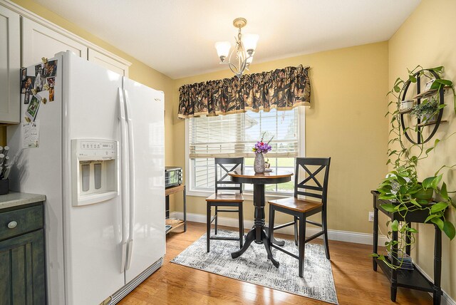 500 Mckinley, Three Rivers, MI 49093 - dining area featuring a chandelier, light wood finished floors, and baseboards