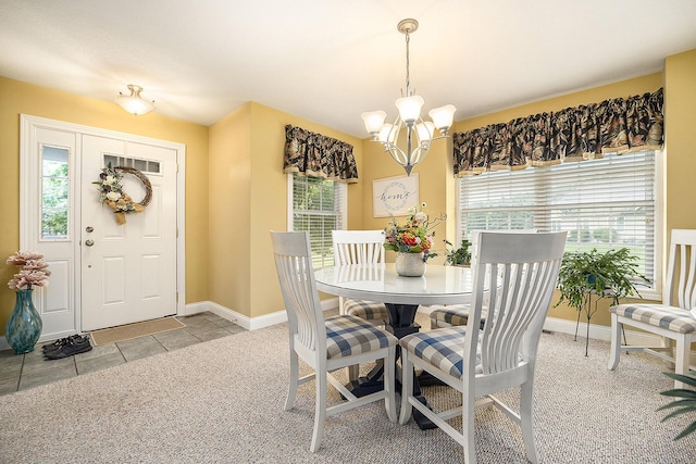 500 Mckinley, Three Rivers, MI 49093 - carpeted dining area featuring tile patterned floors, baseboards, and an inviting chandelier