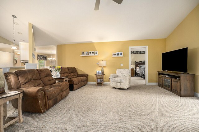 500 Mckinley, Three Rivers, MI 49093 - carpeted living area featuring ceiling fan with notable chandelier, baseboards, and lofted ceiling