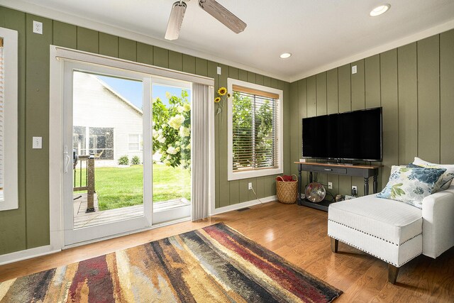 500 Mckinley, Three Rivers, MI 49093 - living area with visible vents, baseboards, crown molding, and wood finished floors