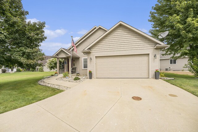 500 Mckinley, Three Rivers, MI 49093 - view of front of home featuring an attached garage, concrete driveway, and a front lawn
