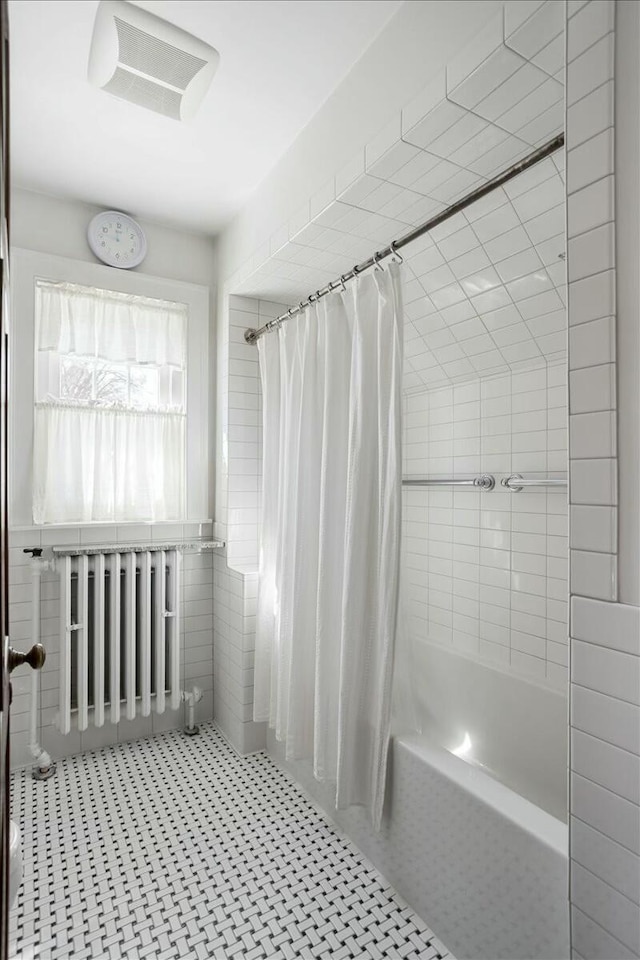 3020 Fulton St SE, Grand Rapids, MI 49506 - bathroom with radiator heating unit and shower / bath combination with curtain