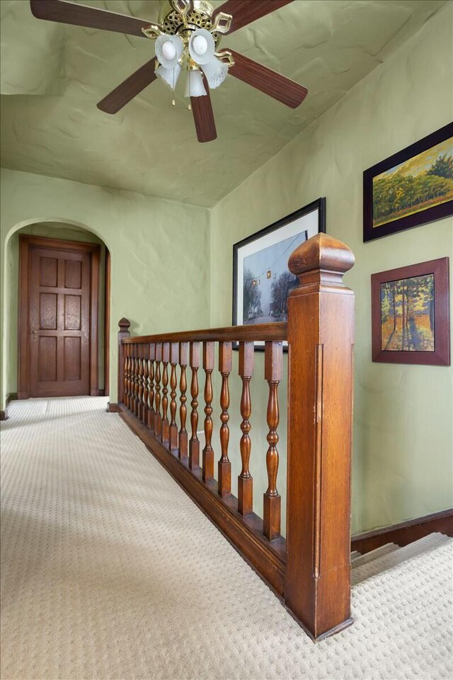 3020 Fulton St SE, Grand Rapids, MI 49506 - hall featuring carpet flooring, arched walkways, baseboards, and an upstairs landing