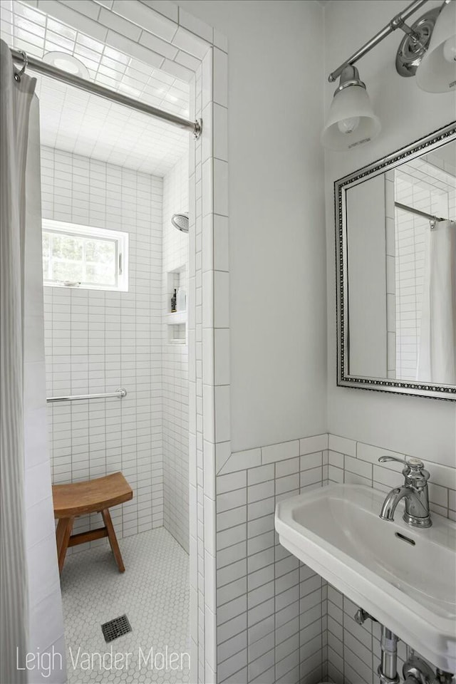 3020 Fulton St SE, Grand Rapids, MI 49506 - full bath with tiled shower, a sink, and tile walls