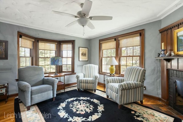 3020 Fulton St SE, Grand Rapids, MI 49506 - sitting room featuring ornamental molding, a ceiling fan, a brick fireplace, baseboards, and wood finished floors