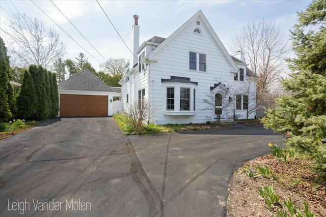 3020 Fulton St SE, Grand Rapids, MI 49506 - view of front of house with a chimney, a detached garage, and an outdoor structure