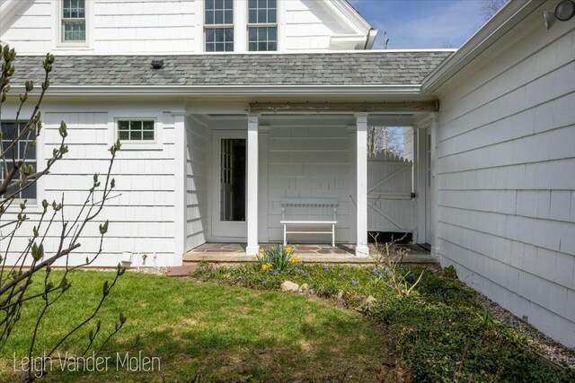 3020 Fulton St SE, Grand Rapids, MI 49506 - property entrance featuring a shingled roof and a yard