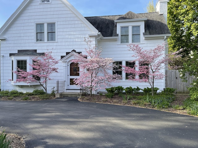 3020 Fulton St SE, Grand Rapids, MI 49506 - view of front of property with a chimney, roof with shingles, and fence