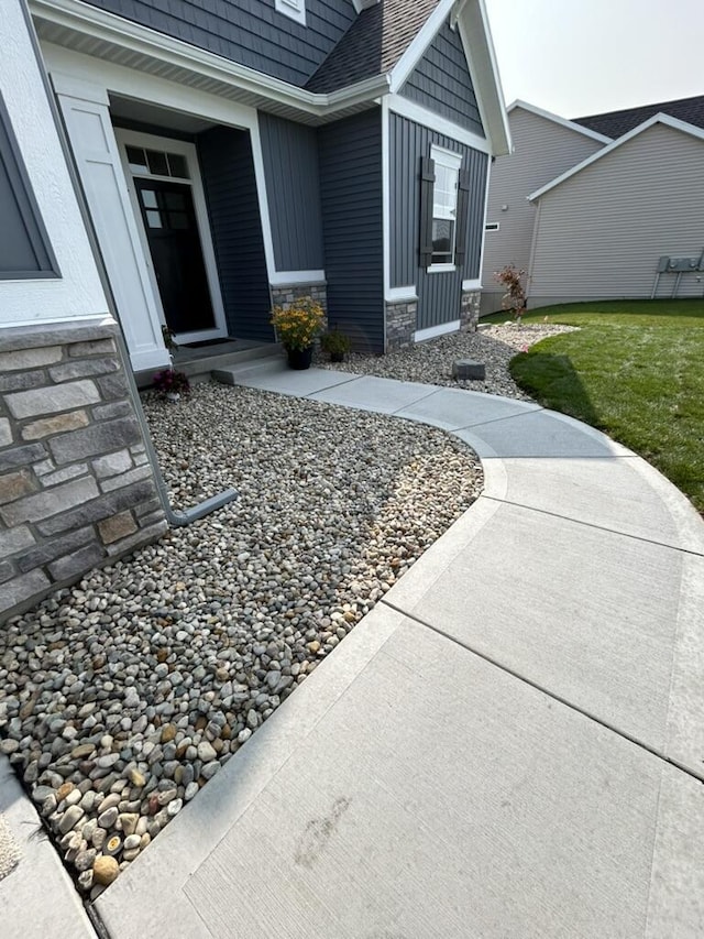 property entrance with stone siding