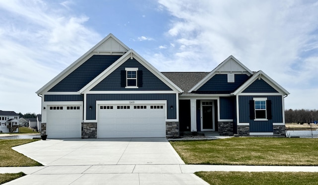 craftsman house with board and batten siding, a front lawn, stone siding, and concrete driveway