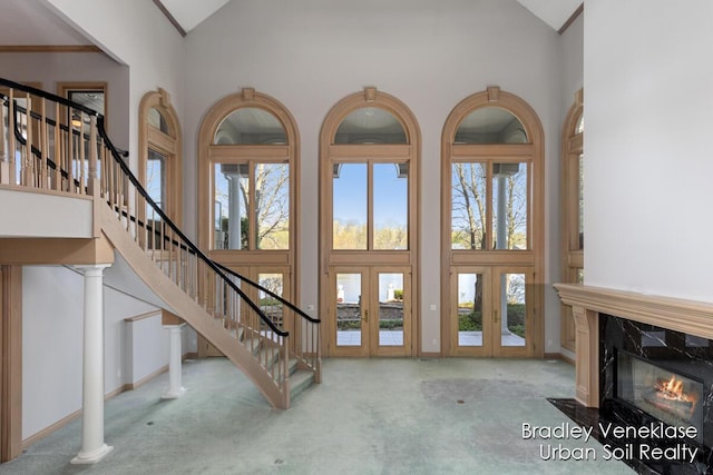 7635 Sandy Hollow Dr SE, Alto, MI 49302 - carpeted foyer entrance with high vaulted ceiling, french doors, plenty of natural light, and stairs