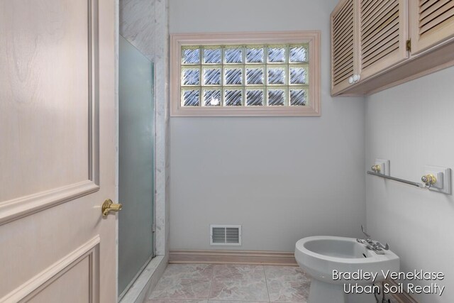 7635 Sandy Hollow Dr SE, Alto, MI 49302 - bathroom featuring a bidet, a shower stall, and baseboards
