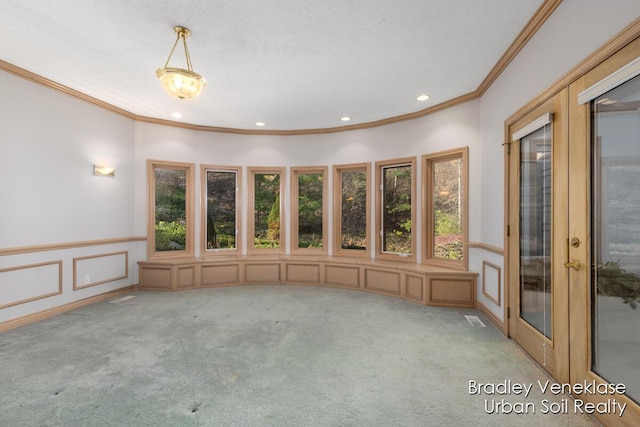7635 Sandy Hollow Dr SE, Alto, MI 49302 - carpeted spare room with crown molding, recessed lighting, wainscoting, a decorative wall, and french doors