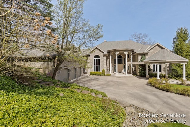 7635 Sandy Hollow Dr SE, Alto, MI 49302 - french country inspired facade featuring driveway