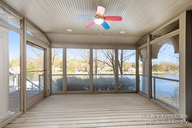 7635 Sandy Hollow Dr SE, Alto, MI 49302 - unfurnished sunroom with a water view, ceiling fan, wood-type flooring, healthy amount of natural light, and wood ceiling
