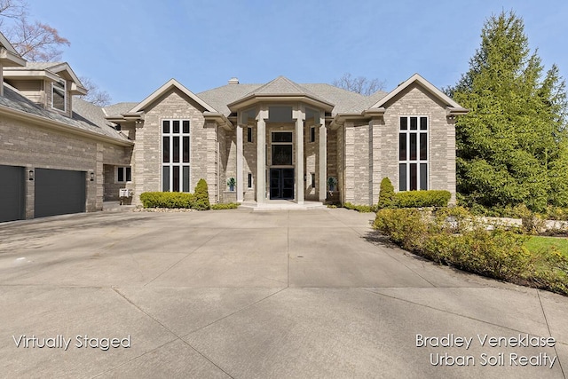 7635 Sandy Hollow Dr SE, Alto, MI 49302 - view of front of property with brick siding, a shingled roof, and driveway