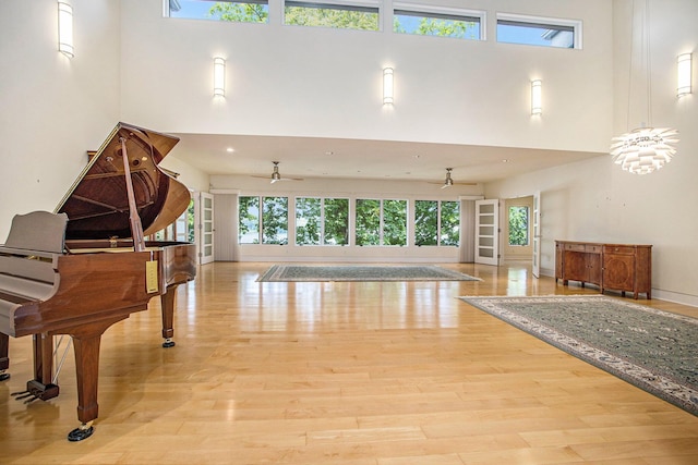 20 Hiawatha Dr, Battle Creek, MI 49015 - living room featuring a towering ceiling, a ceiling fan, plenty of natural light, and wood finished floors