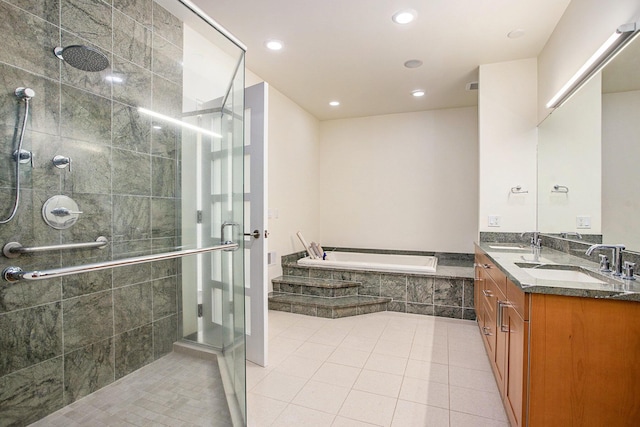 20 Hiawatha Dr, Battle Creek, MI 49015 - bathroom featuring a bath, double vanity, a stall shower, tile patterned flooring, and recessed lighting