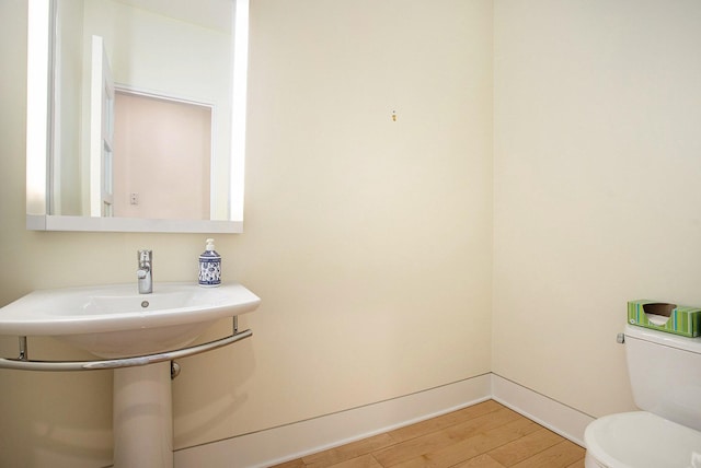 20 Hiawatha Dr, Battle Creek, MI 49015 - half bathroom with toilet and wood finished floors