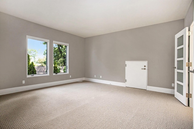 20 Hiawatha Dr, Battle Creek, MI 49015 - unfurnished room with french doors and light carpet
